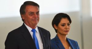 Jair e Michelle Bolsonaro olhando para frente e lado a lado