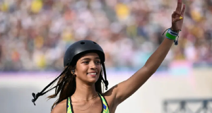 Rayssa Leal sorrindo e acenando na Olimpíada de Paris, de capacete